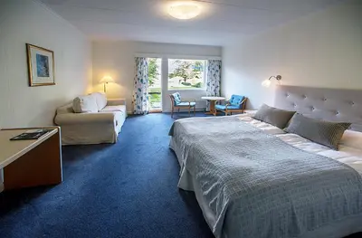 a hotel room with a bed and a couch at Stalheim Hotel in Stalheim