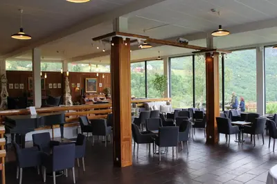 a room with chairs and a bar with windows at Stalheim Hotel in Stalheim