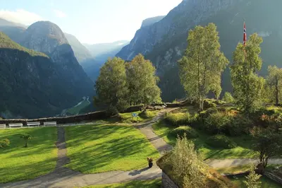 a green field with mountains in the background at Stalheim Hotel in Stalheim