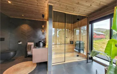 a kitchen with a glass door in a house at Awesome Home In Norheimsund With Sauna in Norheimsund