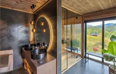 a bathroom with a sink and a mirror at Awesome Home In Norheimsund With Sauna in Norheimsund