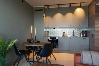 a kitchen with a table and chairs in a room at Riddergaardens eleganse in Beitostøl