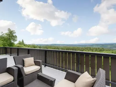 a balcony with chairs and a view of the mountains at 4 star holiday home in Fall-By Traum in Raufoss