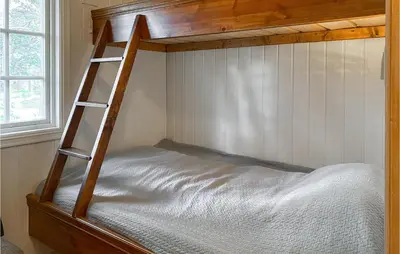 a bunk bed with a ladder in a bedroom at 3 Bedroom Awesome Home In Bjorli in Bjorli