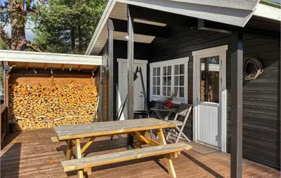 a picnic table on a deck next to a building at 3 Bedroom Awesome Home In Bjorli in Bjorli