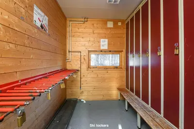 a locker room with red seats in a wooden wall at Hafjell Alpinlandsby Apt 88 in Hafjell