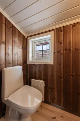 a bathroom with a toilet and a window at Sunny and beautiful cabin in Geilo in Geilo