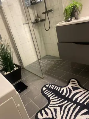 a bathroom with a zebra print rug on the floor at Charming apartment in Meråker in Meråker