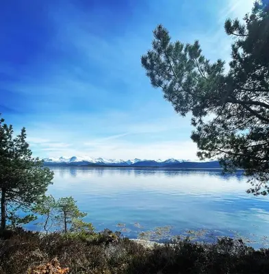 a view of a lake with mountains in the distance at Draget gård, historisk våningshus ved sjøen, rett utenfor Molde in Molde