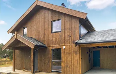a wooden house with a gambrel roof at 4 Bedroom Nice Home In Bjorli in Bjorli
