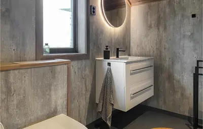 a bathroom with a sink and a mirror at 4 Bedroom Nice Home In Bjorli in Bjorli