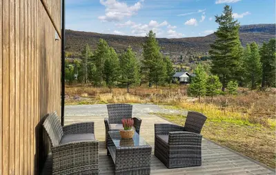 a patio with chairs and a table with a view at 4 Bedroom Nice Home In Bjorli in Bjorli
