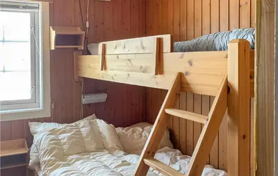 a bunk bed in a wooden room with a bed at 3 Bedroom Lovely Home In Hemsedal in Hemsedal