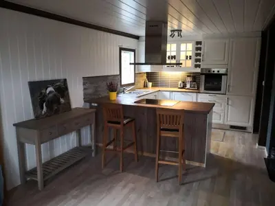 a kitchen with a counter and a island in a room at Feriebolig i Garmo in Lom
