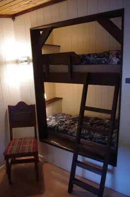 a room with two bunk beds and a chair at Feriebolig i Garmo in Lom