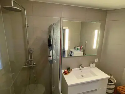 a bathroom with a shower and a sink and a mirror at 6 person holiday home in Bjoa-By Traum in Utbjoa