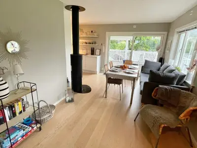 a living room with a living room with a wood stove at 6 person holiday home in Bjoa-By Traum in Utbjoa