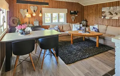 a living room with a table and a couch at Awesome Home In Hjartdal With Kitchen in Hjartdal