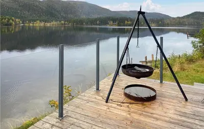a cradle swing on a dock next to a lake at Nice Home In Follafoss With Lake View in Sela