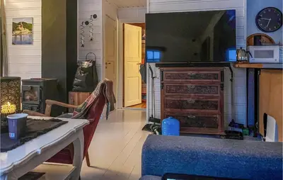 a kitchen with a table and a dresser in a room at Nice Home In Follafoss With Lake View in Sela