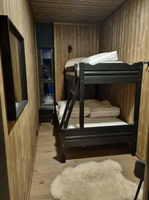 a room with two bunk beds and a rug at Fin leilighet med flott utsikt til Gaustatoppen in Rjukan