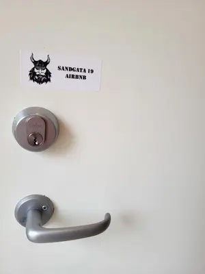 a metal sink with a sign that reads santoku no airport at Mars Modern and Cozy Apartment in the centre, Free Parking in Trondheim