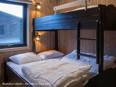 two bunk beds in a room with a window at Hafjelltunet in Hafjell