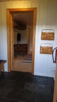 a hallway with a door open to a room with a cow in it at Hallingstue by Hallstensgaard - Geilo in Geilo