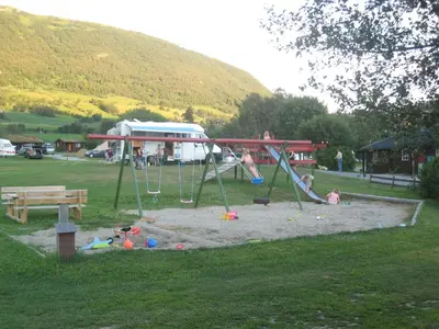 a playground with a swing set in a park at Smegarden Camping in Oppdal