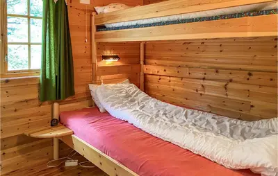 a room with a bed in a log cabin at Beautiful Home In Tustna With Wifi in Gullstein