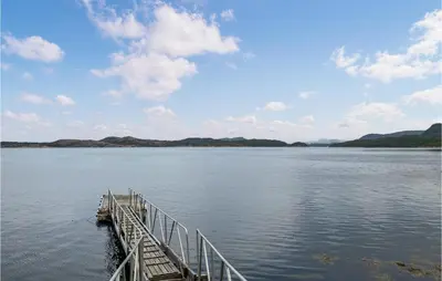 a dock in the middle of a large body of water at Beautiful Home In Tustna With Wifi in Gullstein