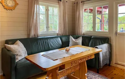 a green leather couch with a wooden table at Beautiful Home In Tustna With Wifi in Gullstein