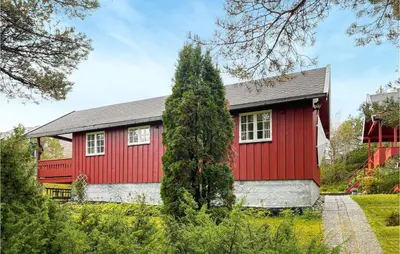 a red house with a tree in front of it at Beautiful Home In Tustna With Wifi in Gullstein