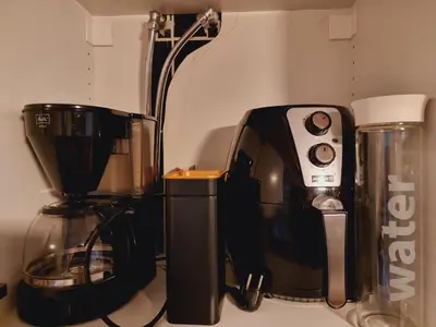 a coffeemaker and a coffee maker sitting on a counter at Kjellerleilighet egen inngang. in Stange