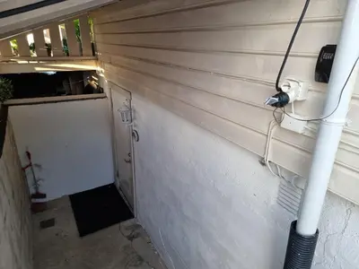 a wall with a hose hooked up to a garage at Kjellerleilighet egen inngang. in Stange