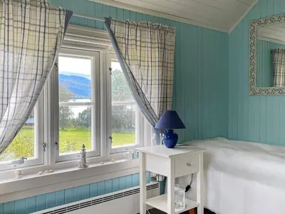 a bedroom with a bed and a window at 6 person holiday home in AVERØY-By Traum in Stein