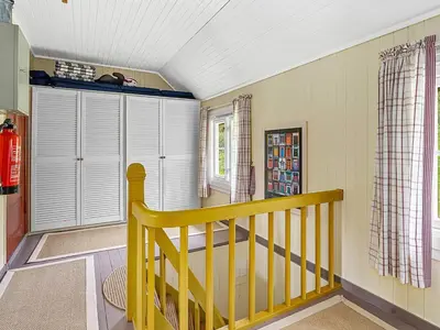 a yellow staircase in a room with a window at 6 person holiday home in AVERØY-By Traum in Stein