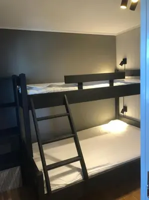 a room with two bunk beds with a ladder at Leilighet i Oppdal - 4 soverom, 2 stuer og 2 bad in Oppdal
