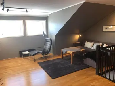 a living room with a bed and a table at Leilighet i Oppdal - 4 soverom, 2 stuer og 2 bad in Oppdal
