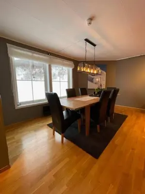 a dining room with a wooden table and chairs at Leilighet i Oppdal - 4 soverom, 2 stuer og 2 bad in Oppdal