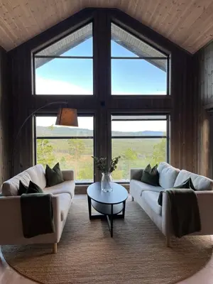 a living room with two couches and a table at Polaren by Norgesbooking - cabin with amazing view in Notodden