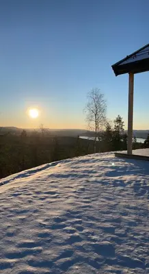 a view of the sun setting on a patio at Polaren by Norgesbooking - cabin with amazing view in Notodden