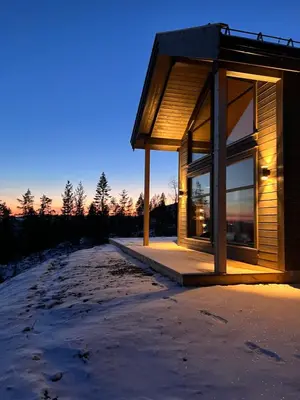 a building in the snow next to a snowy road at Polaren by Norgesbooking - cabin with amazing view in Notodden