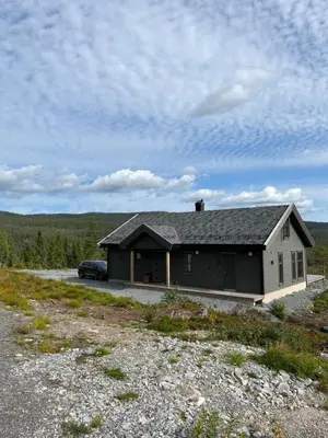 a house with a car parked in front of it at Polaren by Norgesbooking - cabin with amazing view in Notodden