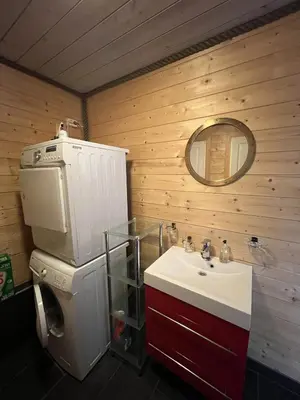 a bathroom with a sink and a toilet and a mirror at Atlantic Road Seaside Housing in Averoy
