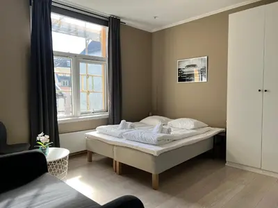 a bedroom with a bed in a room with a window at Vestre Torggaten 20 in Bergen