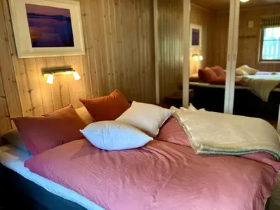 a bed with pillows on it in a room at Skarsnuten Fjellandsby 23, Hemsedal, Ski-in/out in Hemsedal