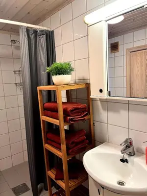 a bathroom with a wooden towel rack next to a sink at Skarsnuten Fjellandsby 23, Hemsedal, Ski-in/out in Hemsedal
