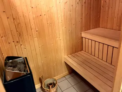 a sauna with a bench and a trash can at Skarsnuten Fjellandsby 23, Hemsedal, Ski-in/out in Hemsedal