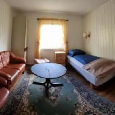 a living room with a couch and a table at Feriehus Voldstad in Syvde